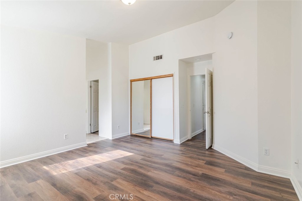 4906 Pacifica Avenue Palmdale, CA 93552 - Photo 21 of 36 a view of room with window and wooden floor