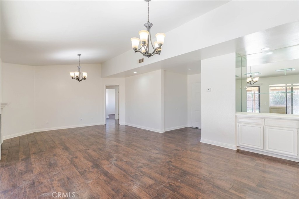 4906 Pacifica Avenue Palmdale, CA 93552 - Photo 10 of 36 wooden floor in an empty room with a window