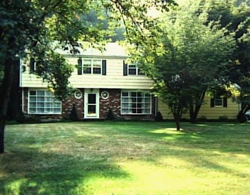 a view of a house with a backyard