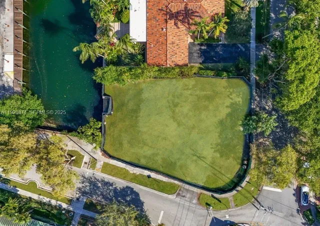 a view of a swimming pool with a yard