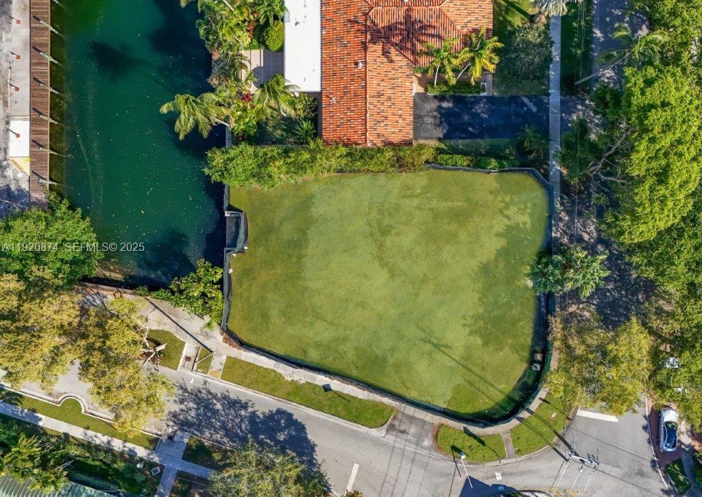 1805 Ixora Road North Miami, FL 33181 - Photo 3 of 7 a view of a swimming pool with a yard