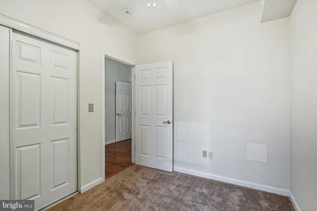 an empty room with chandelier fan