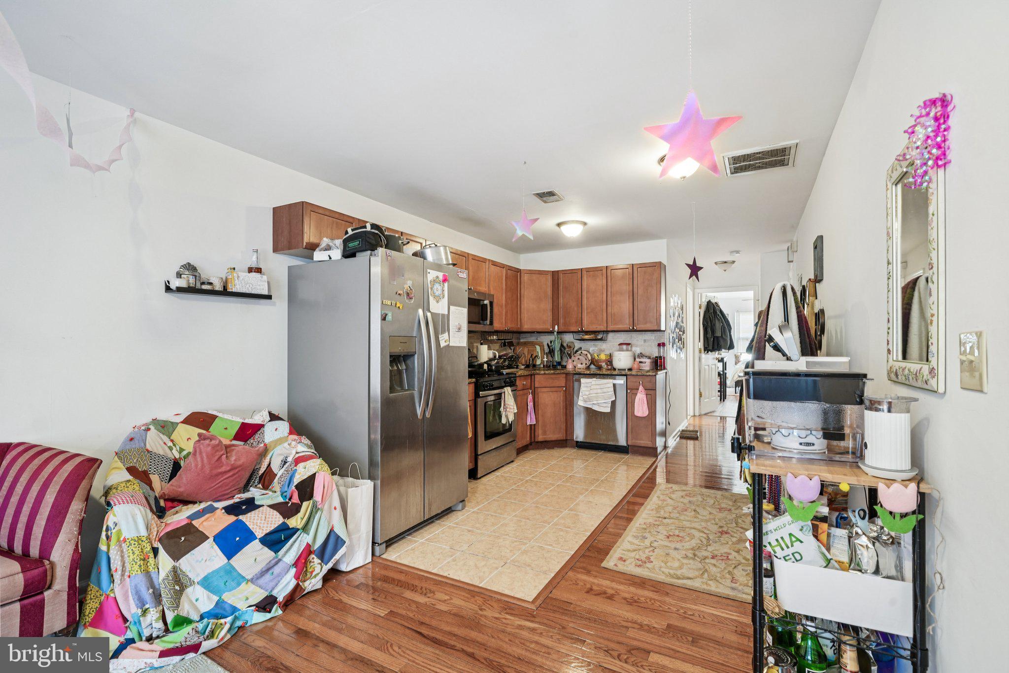 552 North 11th Street Philadelphia, PA 19123 - Photo 27 of 47 a kitchen view with stainless steel appliances wooden floor and chandelier
