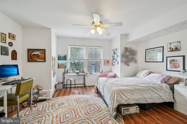 a bedroom with a bed and wooden floor