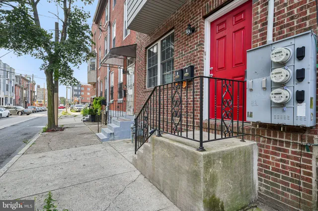 an empty room with wooden floor chandelier fan and windows