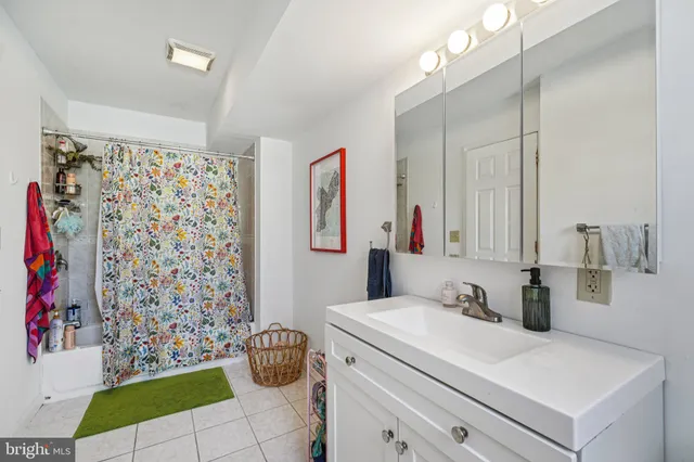 a workspace with furniture hardwood floor and a ceiling fan