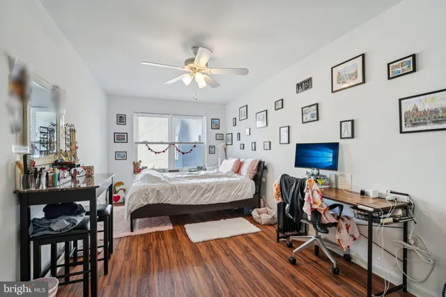 a bedroom with furniture and a wooden floor