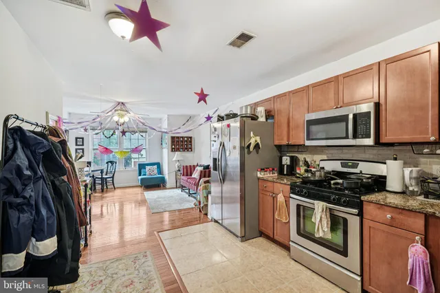 a kitchen with stainless steel appliances a refrigerator and cabinets