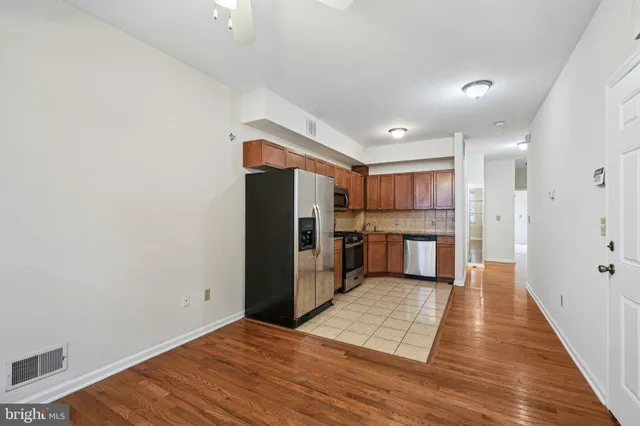 a kitchen with stainless steel appliances granite countertop a refrigerator stove and sink