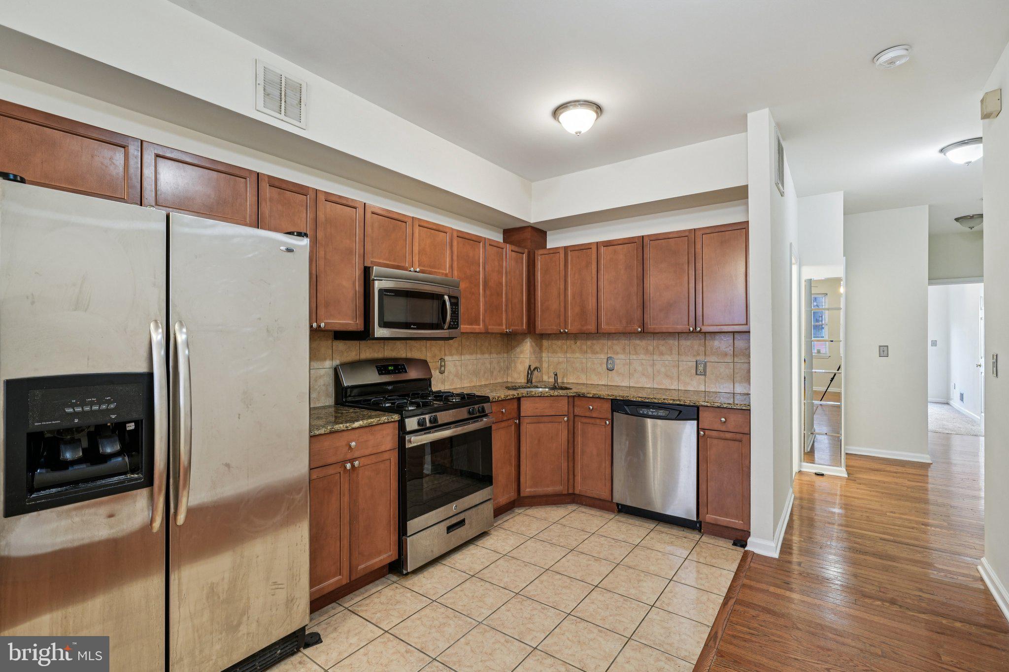 552 North 11th Street Philadelphia, PA 19123 - Photo 10 of 47 a kitchen with stainless steel appliances granite countertop a refrigerator stove and sink