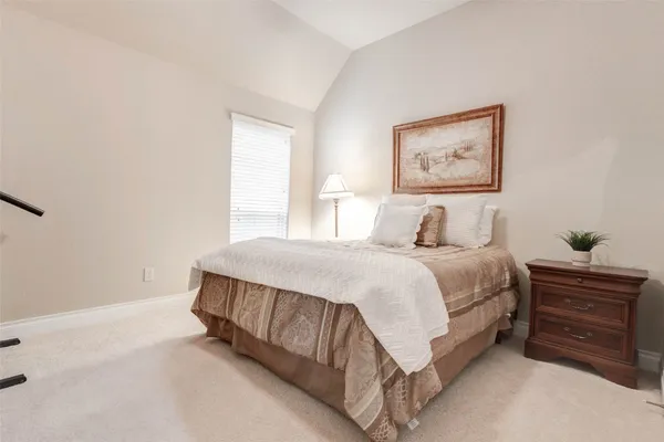 a spacious bedroom with a bed and a window
