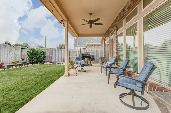 a building outdoor space with patio furniture and garden