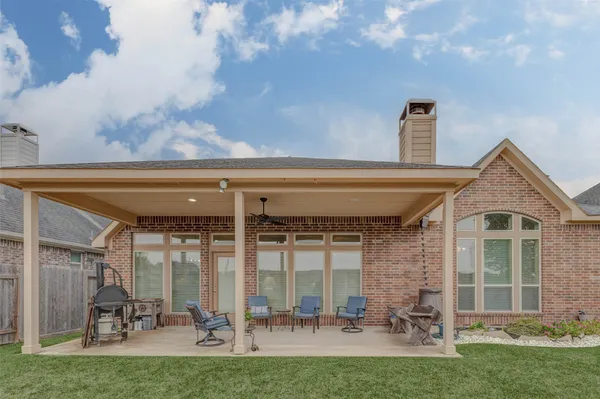 a view of a porch with chairs and backyard