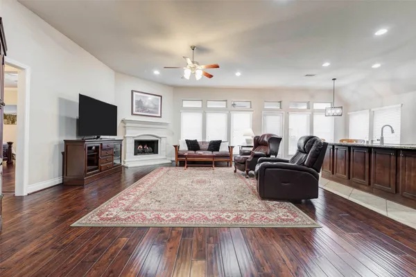 a living room with furniture flat screen tv and fireplace