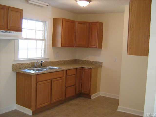 561 Clayton Road Durham, NC 27703 - Photo 3 of 9 a kitchen with a sink and cabinets