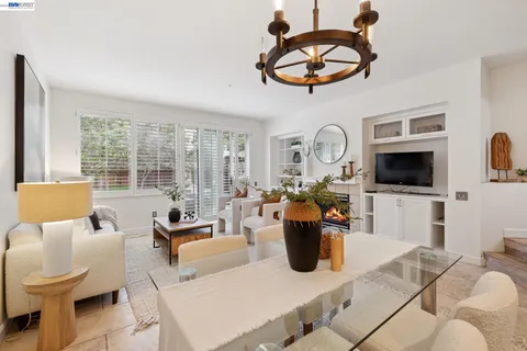 a living room with furniture a flat screen tv and a window