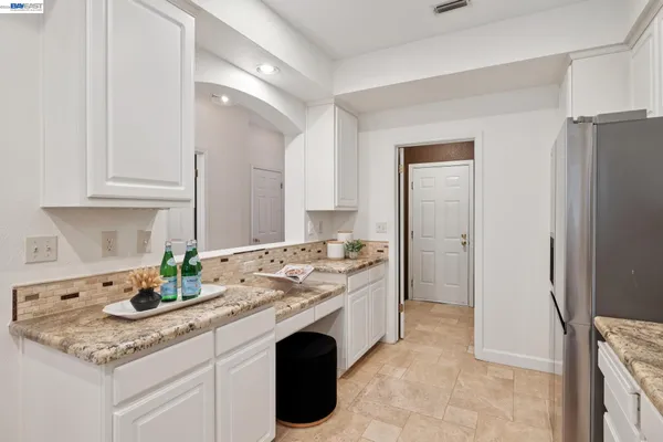 a kitchen with a white stove top oven and sink
