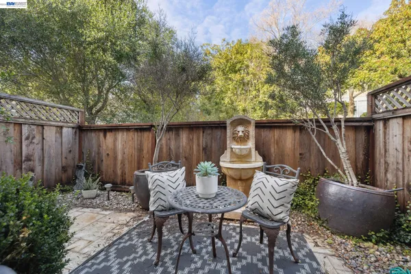 a backyard of a house with table and chairs