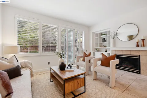 a living room with furniture a fireplace and decor