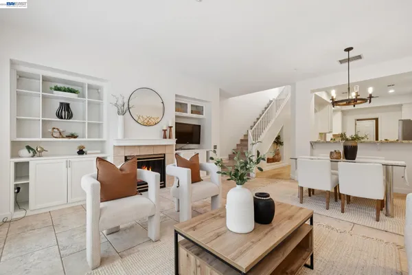 a living room with furniture a fireplace and decor