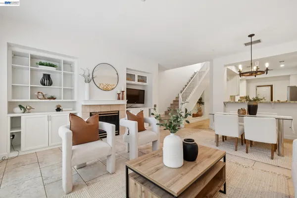 a living room with furniture and floor to ceiling windows