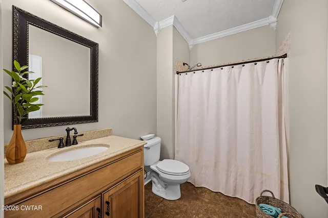 a bathroom with a toilet a sink and a mirror