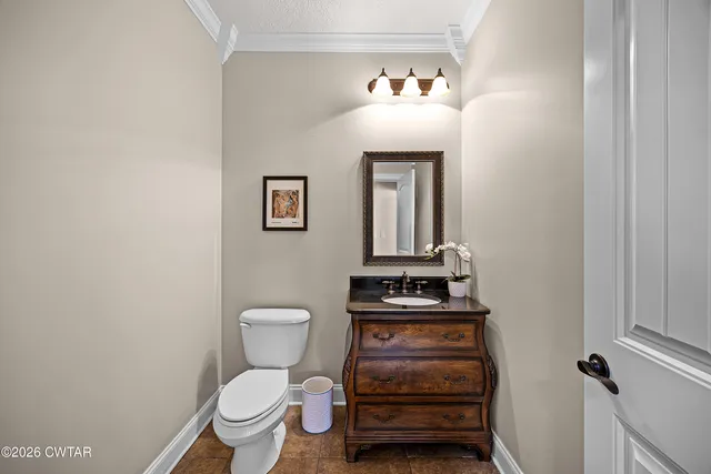 a bathroom with a toilet a sink and vanity