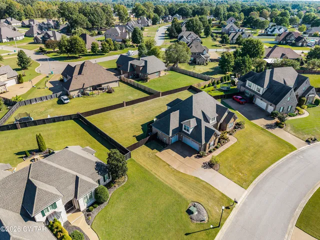 an aerial view of a house with swimming pool and outdoor seating