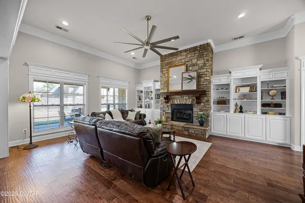 a living room with furniture wooden floor and a fireplace