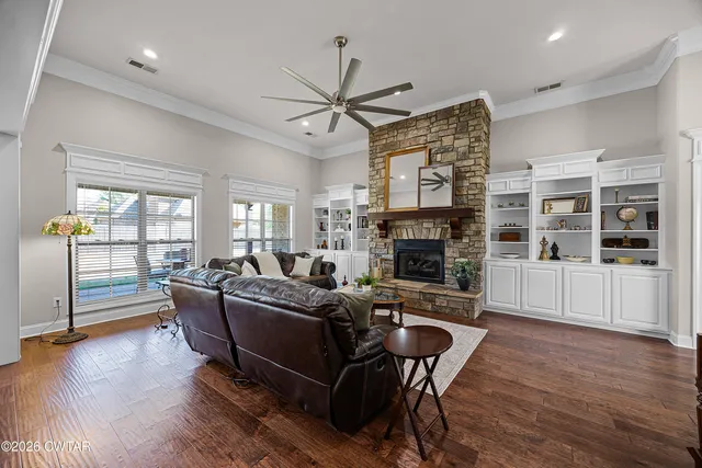 a living room with furniture wooden floor and a fireplace