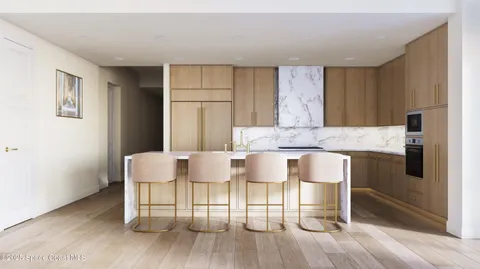 a living room with couches a dining table chairs and kitchen view