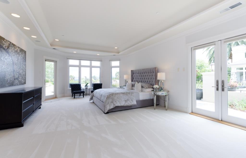 26990 Taaffe Road Los Altos Hills, CA 94022 - Photo 12 of 25 a spacious bedroom with a bed and a large window