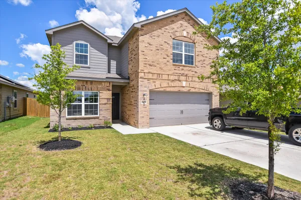 a front view of a house with a yard
