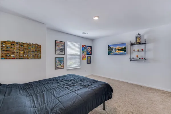 a view of an empty room with closet and windows