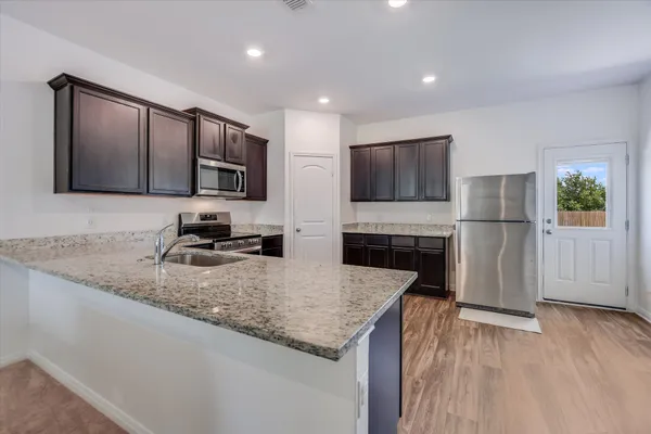 a kitchen with a sink microwave and refrigerator