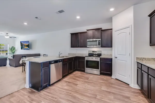 a view of backyard with wooden fence
