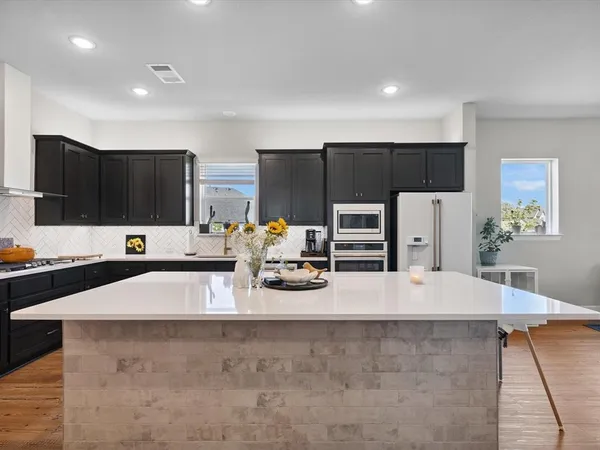 a large kitchen with lots of counter space and refrigerator