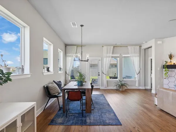 a large white kitchen with lots of counter space a refrigerator and furniture