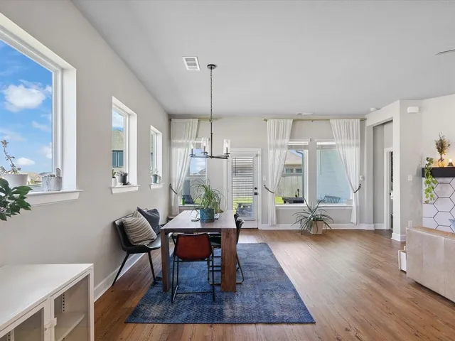 a view of a dining room with furniture window and wooden floor