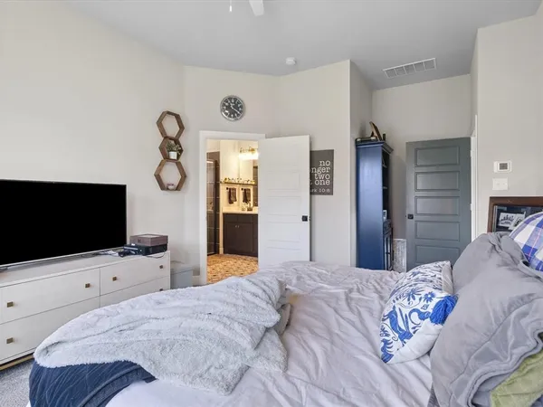 a bedroom with a bed a window and a couch