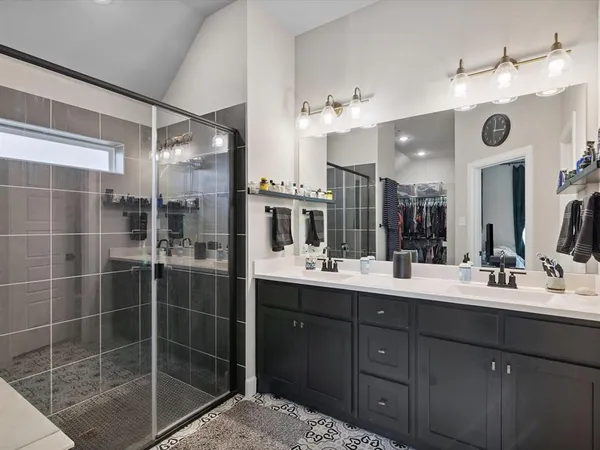 a bathroom with a sink vanity and mirror