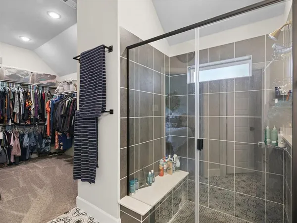 a bathroom with a double vanity sink mirror and shower