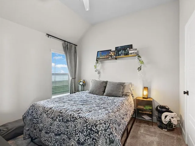 a bedroom with furniture and a book shelf
