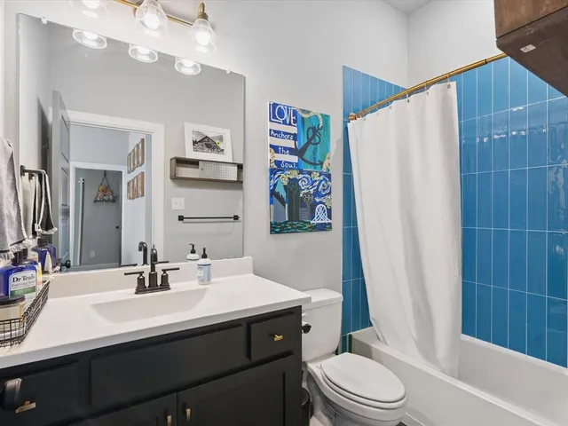 a bedroom with baby crib and a window
