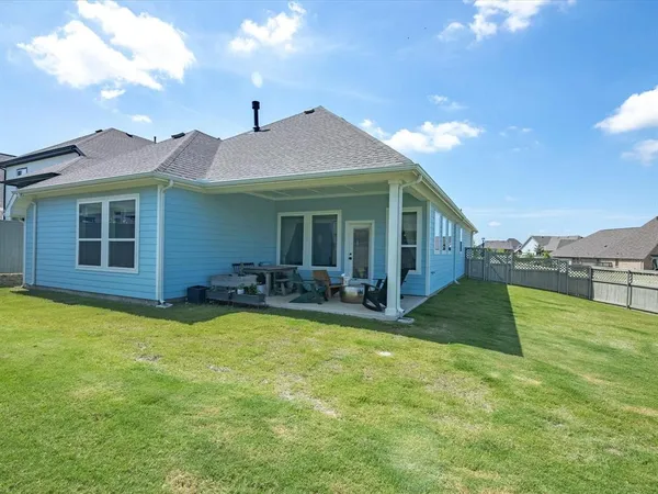 a view of a house with a yard and swimming pool