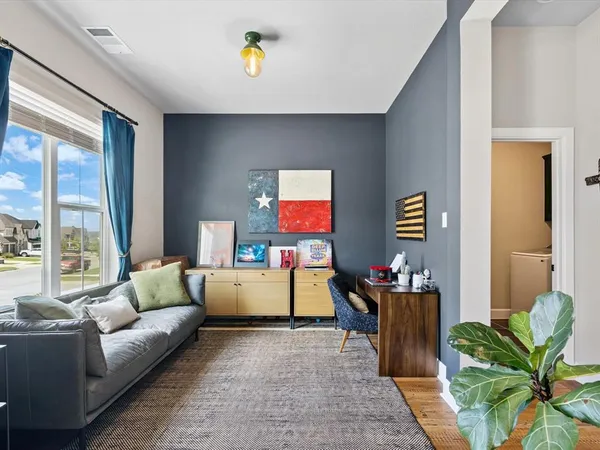 a living room with furniture and a potted plant