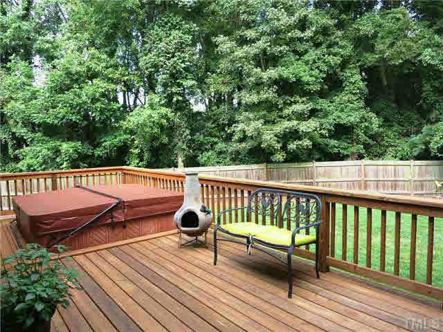 1627 Weatherford Circle Raleigh, NC 27604 - Photo 23 of 25 The 26' long Deck w/hot tub overlooks the PRIVATE fenced backyard surrounded by trees. Patio/Deck