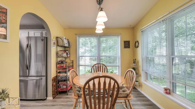 a view of a dining room with furniture window and wooden floor