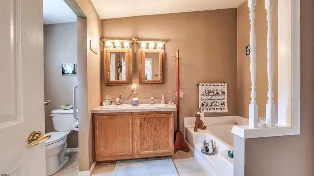 a bathroom with a sink a toilet and mirror