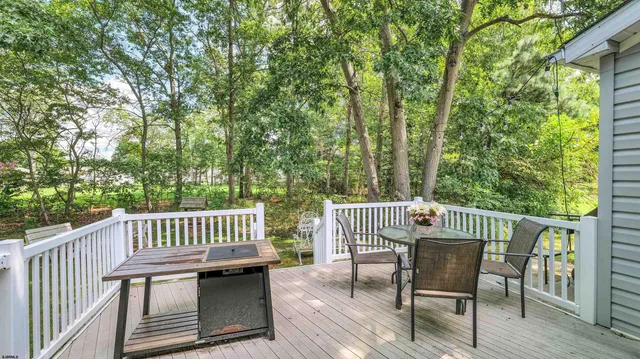 a view of a chair and table on the deck